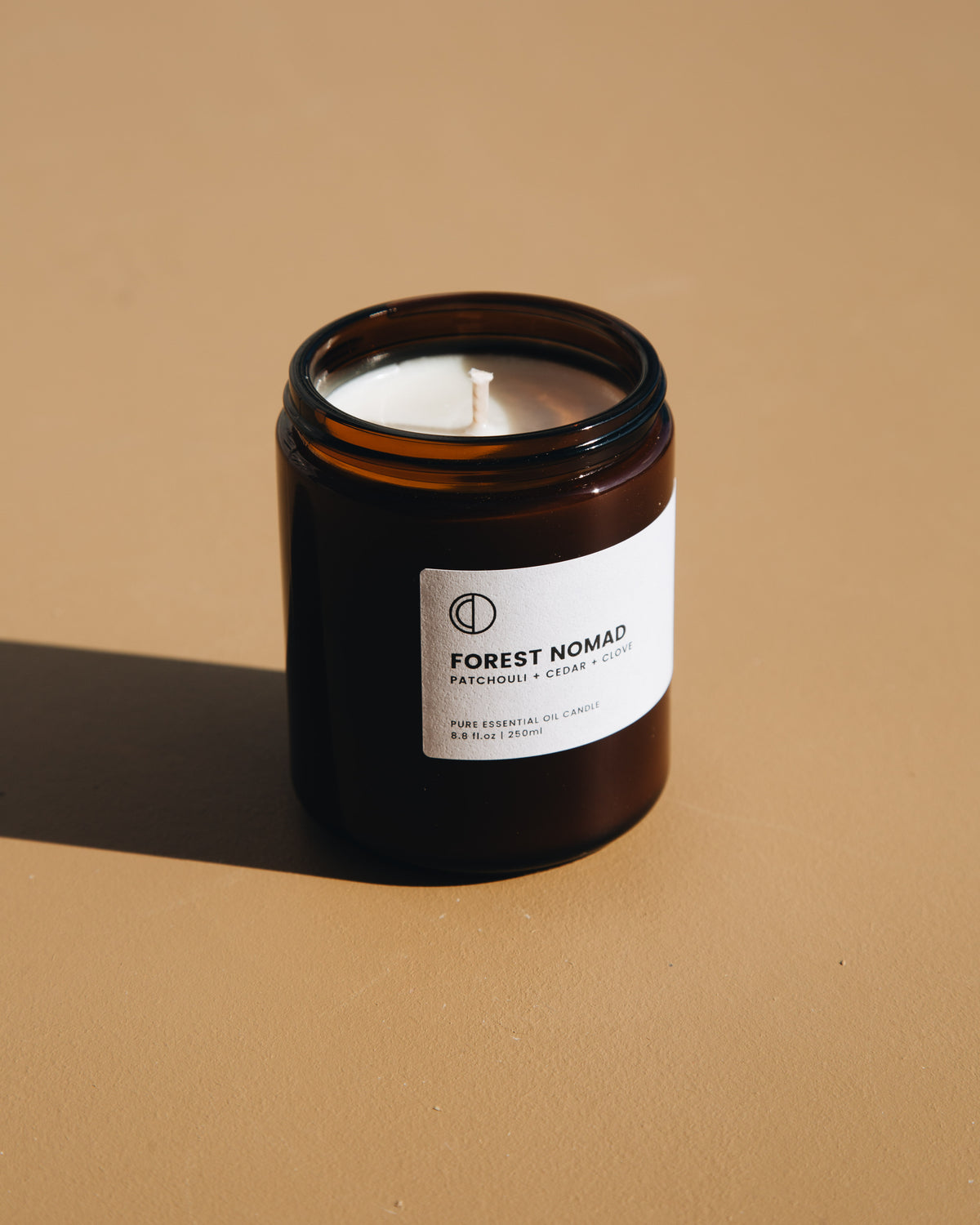 Forest Nomad essential oil candle in amber glass jar by OCTŌ