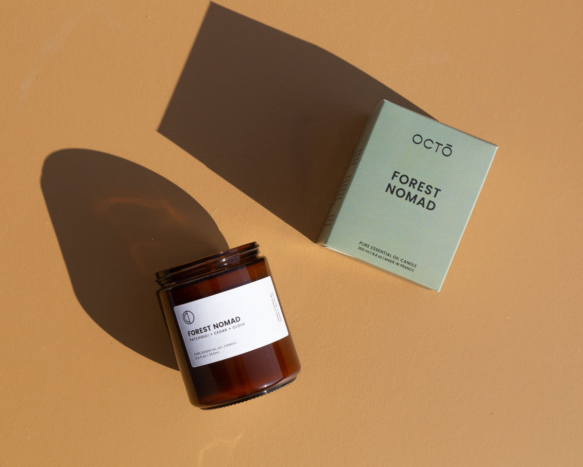 Forest Nomad essential oil candle in amber glass jar by OCTŌ