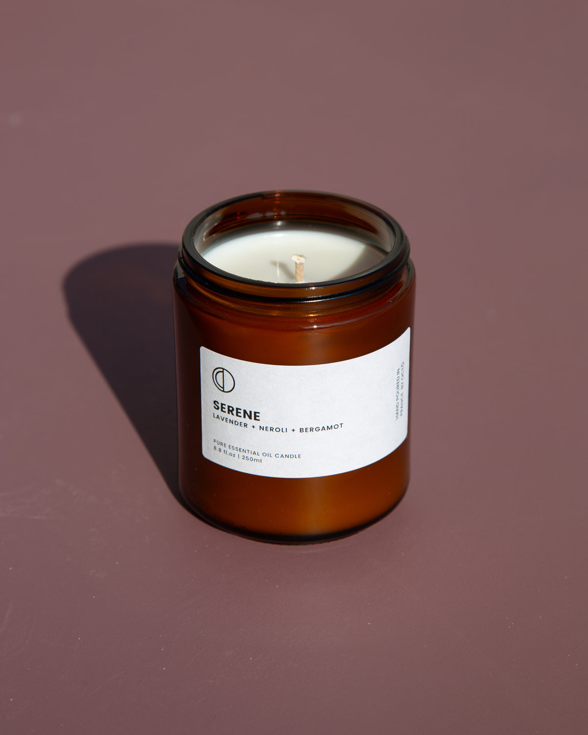 Serene essential oil candle in amber glass jar by OCTŌ