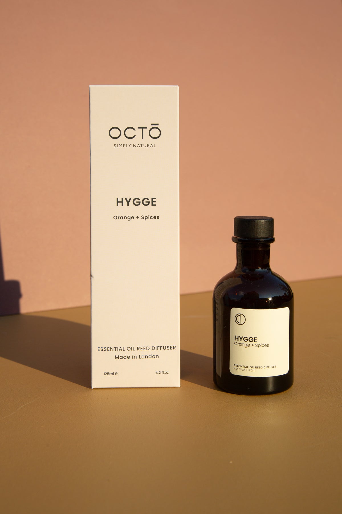 Hygge orange and spice essential oil reed diffuser in amber bottle by OCTŌ